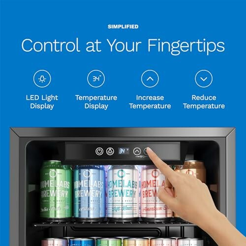 Hand adjusting control panel of beverage cooler with various canned drinks inside.