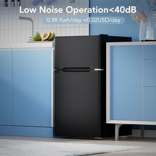 Black refrigerator in a kitchen with blue cabinets, labeled low noise operation under 40dB.