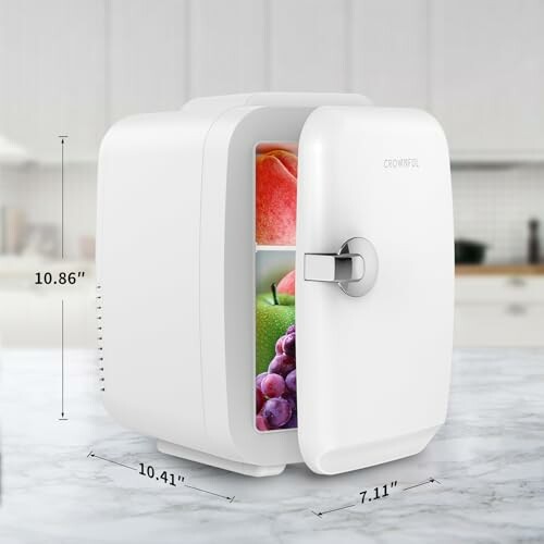 Compact white mini fridge open on kitchen counter.