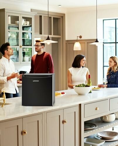 Group of people in a kitchen with a speaker on the counter.
