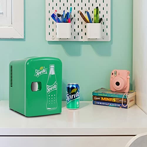 Mini fridge with Sprite can and books on desk
