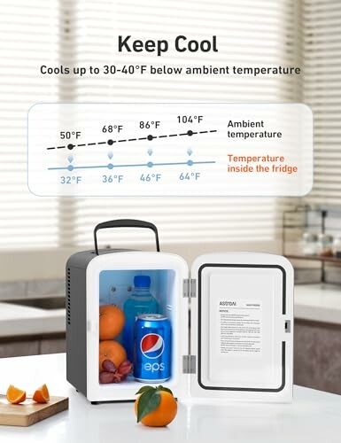 A compact mini fridge showing temperature cooling guide and contents like a soda can and fruit.