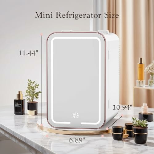 Compact mini refrigerator on a marble countertop with dimensions labeled.