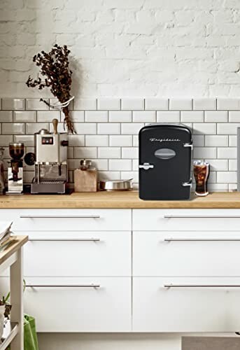 Modern kitchen counter with coffee machine and mini fridge.