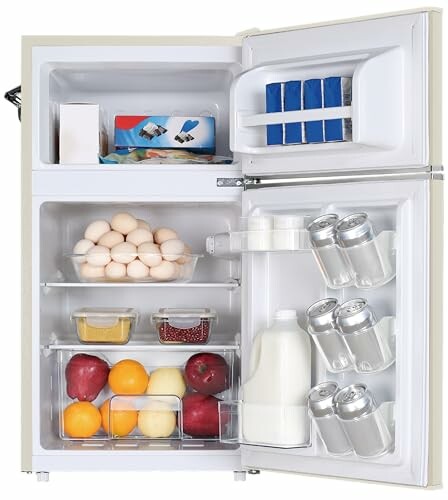 Open refrigerator with eggs, fruit, milk, cans, and packaged items.